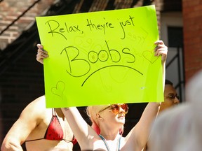 A group of topless women and men wearing bikini tops marched through downtown Toronto to mark  "Go Topless Day." (JACK BOLAND, Toronto Sun)