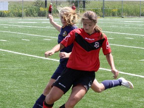 Greater Sudbury Impact's Cassidy Burton, front, battles for the ball with Whitby's Allyson Garnett in Central Girls Soccer League play at James Jerome Sports Complex on Sunday. Ben Leeson/The Sudbury Star/Postmedia Network