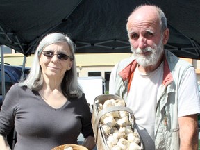 Henriette Dauphinais (left) and Gerald Beaulieu, organic gardeners from Wanup, show off some of their wares at the Canadian Garlic Festival in Sudbury on Sunday. Ben Leeson/The Sudbury Star/Postmedia Network