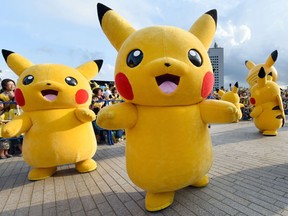 File photo of people dressed up as Pikachu, the famous character of Nintendo's videogame software Pokemon, dancing with fans as the final of a nine-day "Pikachu Outbreak" event takes place to attract summer vacationers in Yokohama, in suburban Tokyo, on August 16, 2015.      AFP PHOTO / Toru YAMANAKA/ Files
