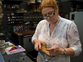 Judith Bailey, who has been fixing shoes for 25 years, works on a heel at the Serratore Shoe Repair shop she manages in London?s CitiPlaza. (MIKE HENSEN, The London Free Press)