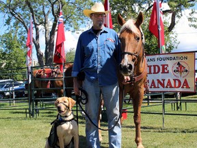 Lawrence Christensen with service dog Lynx, and his transportation for the day Skip, as part of the Communities for Veterans Foundation's Ride Across Canada, which stopped in Kingston. on Saturday.  Steph Crosier/The Whig-Standard