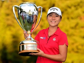 Lydia Ko of New Zealand poses with the trophy after the final round of the Canadian Pacific Women's Open at the Vancouver Golf Club on August 23, 2015 in Vancouver, Canada.   Harry How/Getty Images/AFP