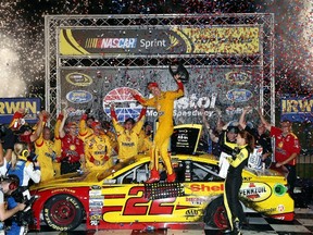 Joey Logano, driver of the No. 22 Shell Pennzoil Ford, celebrates in Victory Lane after winning the NASCAR Sprint Cup Series IRWIN Tools Night Race at Bristol Motor Speedway on Saturday. (Getty Images/AFP)