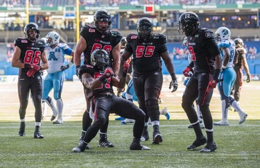Ottawa RedBlacks' Jeremiah Johnson celebrates his touchdown with teammates against the Toronto Argonauts during the first half of CFL football action in Toronto on Sunday, August 23, 2015. THE CANADIAN PRESS/Mark Blinch