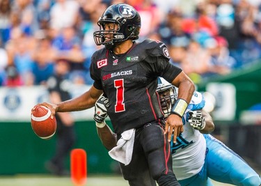 Ottawa RedBlacks quarterback Henry Burris, top, is sacked by Toronto Argonauts Vincent Desloges during the second half of CFL football action in Toronto on Sunday, August 23, 2015. THE CANADIAN PRESS/Mark Blinch