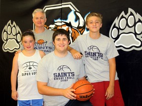 Quinte Secondary School principal and basketball coach, Liane Woodley, with 10-year-old Grace LaCroix, Dave Taylor, 18, and Mathew Berry, 13, at the Saints Summer School Basketball Camp in Belleville Friday. During the camp, Quinte Secondary School and the Belleville Spirits Basketball Club were also promoting the club’s first every city-wide house league to begin in September.