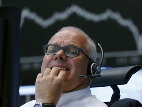 A trader reacts at his desk in front of the DAX board at the Frankfurt stock exchange, Germany, August 24, 2015. (REUTERS/Ralph Orlowski)