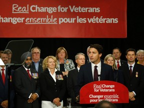 Federal Liberal leader Justin Trudeau speaks to supporters and local veterans during an election stop in Belleville, Ont. Monday, August 24, 2015. He told the group at the Quinte Sports and Wellness Centre he would, if elected, increase funding for programs supporting veterans and their families. Over his right shoulder are retired general turned Orleans, Ont. Liberal candidate Andrew Leslie, former commander of the Canadian army in Afghanistan, and to Leslie's right, candidate Karen MacCrimmon, a former squadron commander at CFB Trenton.