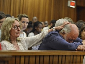 Barry Steenkamp, father of Reeva Steenkamp, is consoled by his wife June Steenkamp during the sentencing hearing of Olympic and Paralympic track star Oscar Pistorius at the North Gauteng High Court in Pretoria on October 15, 2014.  (REUTERS/Antoine de Ras)