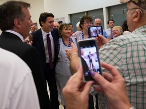 TIM MILLER/THE INTELLIGENCER
Liberal leader Justin Trudeau stops to have his picture taken with a group of people after his speech at the Quinte Sports and Wellness Centre on Monday in Belleville. Trudeau stopped multiple times on his way out of the building to have his picture taken with supporters.