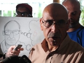 Airport taxi union boss Abed Madi speaks to reporters after demanding Mayor Jim Watson intervene in the labour dispute that has seen Coventry Connections lock out cab drivers who refuse to pay an extra fee for stopping at the airport. (TONY SPEARS/Ottawa Sun/Postmedia Network)