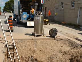Hanna & Hamilton Construction Ltd. streetscape sub-contractors enlisted N-Two Cryogenic Enterprise Inc. to freeze a portion of the water main on Ontario Road Aug. 12 so workers could connect the new water main under Ontario Road to the old main running under St. George Street without interrupting neighbouring businesses' and apartments' access to water. GALEN SIMMONS/MITCHELL ADVOCATE