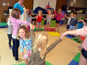 Evonne Van Nynatten (left) runs through the “windows” created by her camp mates as everyone sings a song about a blue bird at A Brand New Beat's Music and Art a la Carte summer camp at the Mitchell community centre Aug. 21. GALEN SIMMONS/MITCHELL ADVOCATE