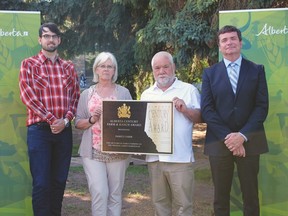 The Mitchell family receives the Alberta Century Farm and Ranch Award from Agriculture and Forestry Minister Oneil Carlier (far right) last month. Generations of the family have farmed on the same land in Strathcona County for more than 100 years. Photo supplied.