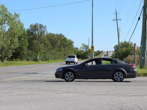 SAMANTHA REED/FOR THE INTELLIGENCER
A car waits to make a left turn at the intersection of Hamilton and Wallbridge-Loyalist roads Monday afternoon. City official Rod Bovay says residents should not be expecting to see a set of lights at the intersection anytime soon.