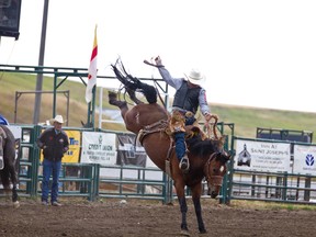 Kyle Thomson rides his second bronc on Saturday July 15,2015 at the Pincher Creek Pro rodeo. Thomson finished the weekend with a score of 81.5.