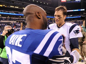New England Patriots quarterback Tom Brady and Indianapolis Colts receiver Reggie Wayne (87) embrace after their game at Lucas Oil Stadium last season. (Thomas J. Russo/USA TODAY Sports)