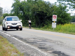 A vehicle heads southbound on Waterworks Road towards Michigan Road on Monday August 24, 2015 in Bright's Grove, Ont. The city will be reducing the speed limit to 60 km/h temporarily along the rural road due to its deteriorating state. (Barbara Simpson/Sarnia Observer/Postmedia Network)