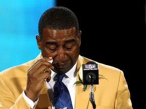 Cris Carter wipes a tear as he talks during his acceptance into the NFL Pro Football Hall of Fame in Canton, Ohio August 3, 2013. (REUTERS/Aaron Josefczyk)