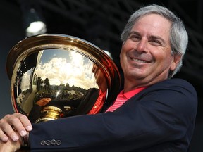 U.S. team captain Fred Couples poses for photographers after defeating the International team to retain the Presidents Cup at Royal Melbourne Golf Club in Melbourne November 20, 2011. (REUTERS/Brandon Malone)