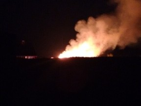 A Quonset hut caught on fire Sunday night, destroying nearly 1,700 bales of straw on a cattle farm on Beaconsfield Road, west of Highway 59. (Photo courtesy of Mason Schneider)