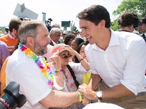 Liberal Leader Justin Trueau, right, greets NDP Leader Thomas Mulcair during a federal election campaign stop at the annual gay pride parade in Montreal, Sunday, August 16, 2015. (THE CANADIAN PRESS)