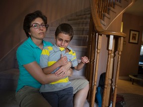 Leslie Lander and her autistic son Jordan in their Kanata home Monday afternoon. On Friday, Jordan ran from the backyard but was later found by an off-duty police officer who saved the boy from being hit by traffic. (DANI-ELLE DUBE/OTTAWA SUN)