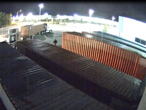 Thieves in stolen trucks hook on to trailers full of sportswear outside the Columbia Sports warehouse in this photo released by police. (Special to the Free Press)