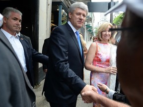 Conservative leader Stephen Harper shakes hands with members of the public as he makes an impromptu campaign stop in Quebec City, Que., on Aug. 25, 2015. (THE CANADIAN PRESS/Sean Kilpatrick)