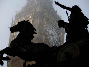 In this Thursday, March 15, 2012 file photo, the Boudica statue stands in the foreground as fog shrouds the clock tower which houses the Big Ben bell at the Palace of Westminster, London. Officials on Tuesday, Aug. 25, 2015 said that the famous clock at Britain's Parliament, used by people across Britain to check the time, has recently been slow by as much as six seconds. (AP Photo/Matt Dunham, File)