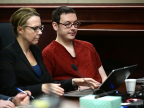 James Holmes, right, with defence attorney Katherine Spengler, appears in court for the sentencing phase in his trial, Monday, Aug. 24, 2015, at Arapahoe County District Court in Centennial, Colo. Victims and their families were given the opportunity to speak about the shooting and its effects on their lives. Holmes was convicted Aug. 7 of murdering 12 people when he opened fire on a crowded movie theatre in 2012. (RJ Sangosti/The Denver Post via AP, Pool)