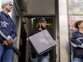 Law enforcement officers seize evidence from the Manhattan offices of Rentboy.com in New York August 25, 2015.  U.S. authorities on Tuesday announced the arrest of the chief executive officer and six employees of Rentboy.com, which prosecutors described as the largest online male escort service. Rentboy.com CEO Jeffrey Hurant and the employees were charged in a criminal complaint filed in federal court in Brooklyn, New York, with conspiring to violate the Travel Act by promoting prostitution.  REUTERS/Brendan McDermid