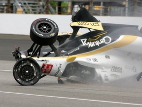 In this May 14, 2015, file photo, the car driven by Josef Newgarden slides down the track after hitting the wall in the first turn and going airborne during practice for the Indianapolis 500 at Indianapolis Motor Speedway. (AP Photo/Joe Watts, File)