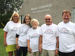 Standing outside their church in Kingston on Tuesday, which is sponsoring a family of refugees from Eritrea, are, from left, Gail Power, Heidi De Jonge, Greta Boven, Fred Boven and Ryan Power. (Michael Lea/The Whig-Standard)