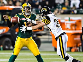Hamilton DB Mike Daly, shown here stripping the ball from Eskimos QB James Franklin, was busy Friday with two interceptions, seven tackles, a forced fumble and a sack. (Codie McLachlan, Edmonton Sun)