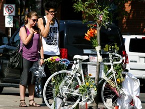 People mourn at a memorial site at 101 St., and Whyte Ave., where Isaak Kornelsen was killed in a bicycle accident with a fully loaded cement truck in Edmonton. PERRY MAH/EDMONTON SUN