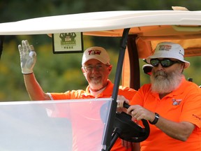 Rick Turner waves as he and his partner Jim Backs cart up the 16th fairway at Dragonfly Golf Links in Renfrew (Ontario), Tuesday, August 25, 2015. Ottawa Sun Scramble. Absolute Comedy C Division. Dragonfly Golf Links. MIKE CARROCCETTO / OTTAWA SUN /POSTMEDIA NETWORK