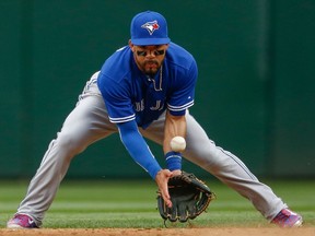 Injured Blue Jay Devon Travis has been trying to rehab his left shoulder for a month now. (Getty Images/AFP)