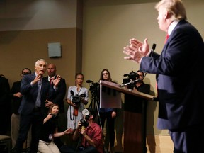 Miami-based Univision anchor Jorge Ramos, left, asks Republican presidential candidate Donald Trump a question about his immigration proposal during a news conference, Tuesday, Aug. 25, 2015, in Dubuque, Iowa. Ramos was later removed from the room. (AP Photo/Charlie Neibergall)