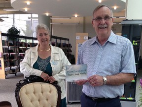 St. Thomas Public Library CEO Rudi Denham, left, and board chairman Greg Grondin stand with antique furniture from the Mary Ann Neely estate. The library announced a $1 million donation from the estate Tuesday afternoon. The money will be used to build a glass atrium at the front of the bulding.