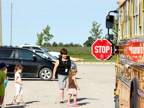 Future JK and SK students with their parents learning the rules of riding a school bus.