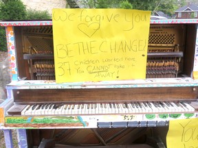 A sign the reads “We forgive you. Be the change. 37 children worked here, you cannot take it away” was put on one of the damaged pianos by a local resident to condemn the incident.