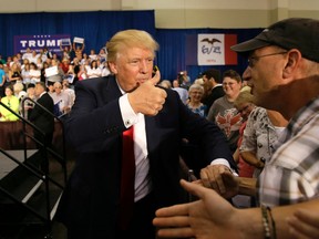 Republican presidential candidate Donald Trump greets supporters during a rally, Tuesday, Aug. 25, 2015, in Dubuque, Iowa. (AP Photo/Charlie Neibergall)