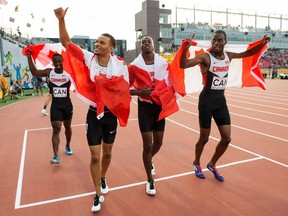 Canadian teammates celebrate after the men's 4x100 at the 2015 Pan Am Games in Toronto on Saturday, July 25, 2015. The Canadian men's 4x100-metre relay team was disqualified at the Pan American Games, denying sprinter Andre De Grasse a third gold medal. (Frank Gunn/THE CANADIAN PRESS)