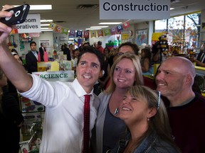Liberal leader Justin Trudeau takes a photo with teachers while visiting a education supply store Wednesday, August 26, 2015 in Newmarket, Ont. THE CANADIAN PRESS/Paul Chiasson