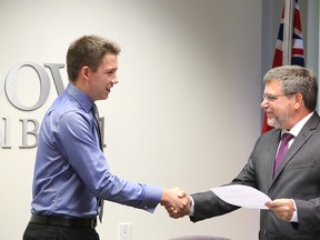 Rainbow District School Board director of education Norm Blaseg welcomes Ethan Urban, a Grade 12 student at Lockerby Composite School, as student trustee for the 2015-16 school year after being sworn in at the board meeting on Tuesday, August 25, 2015. Gino Donato/Sudbury Star/Postmedia Network