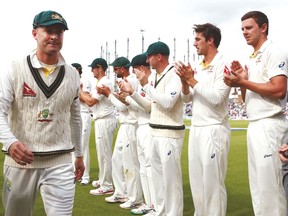 Australia’s Michael Clarke walks off the pitch past his Australian teammates after ending his final test match at the Ashes against England. (AP)