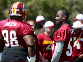 Washington Redskins defensive tackle Terrance Knighton, left, talks with newly signed teammate Junior Galette during the team’s training camp in Richmond, Va., Friday, July 31, 2015. (AP Photo/Jason Hirschfeld)