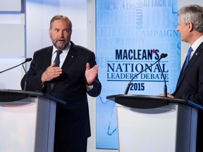 Canada's NDP leader Thomas Mulcair (L) speaks while Conservative leader Prime Minister Stephen Harper looks on during the Maclean's National Leaders debate in Toronto, August 6, 2015. Canadians go to the polls in a national election on October 19, 2015. REUTERS/Frank Gunn/Pool